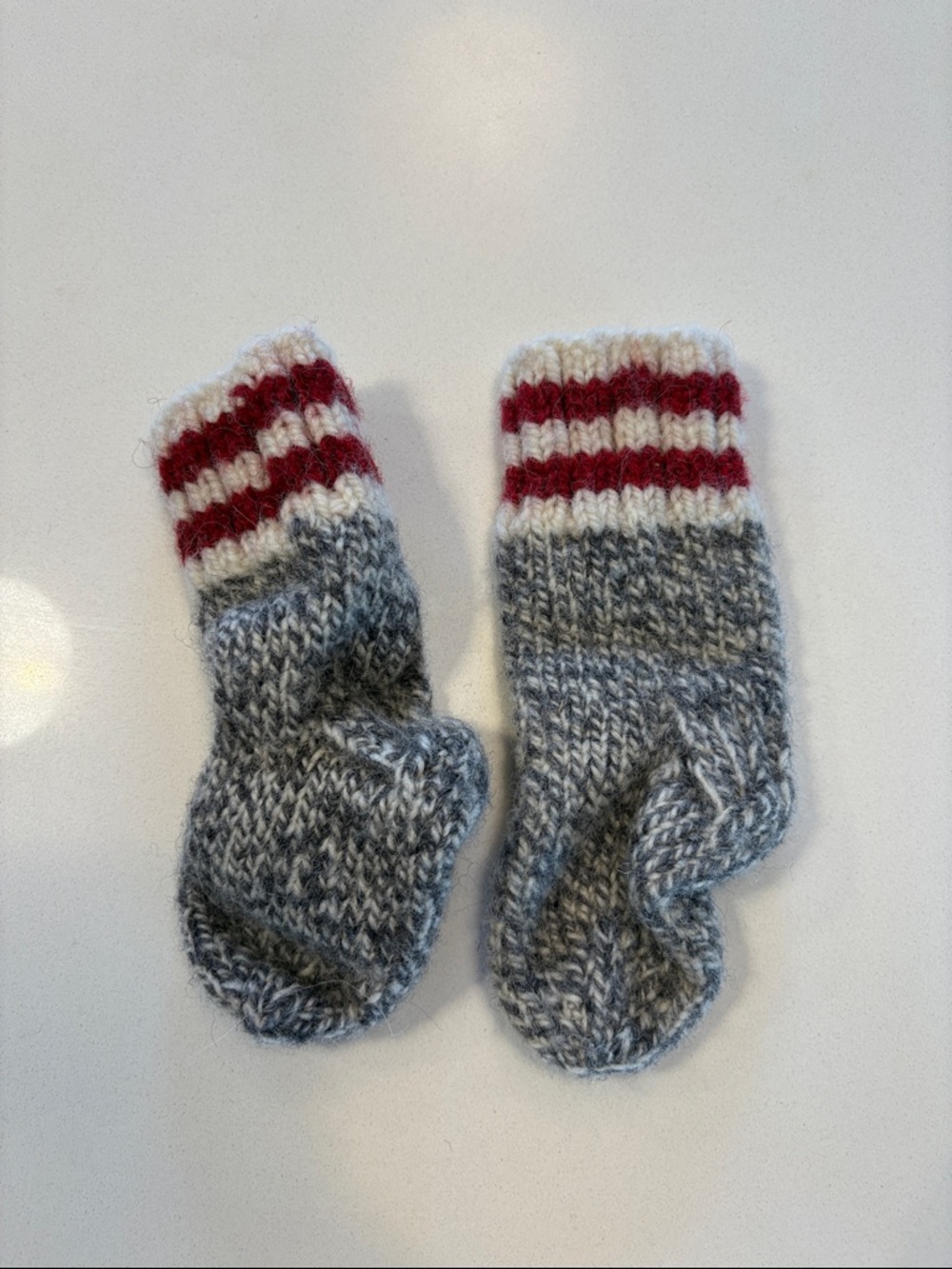 Hand-Knit Gray and White Baby Socks with Red Stripe